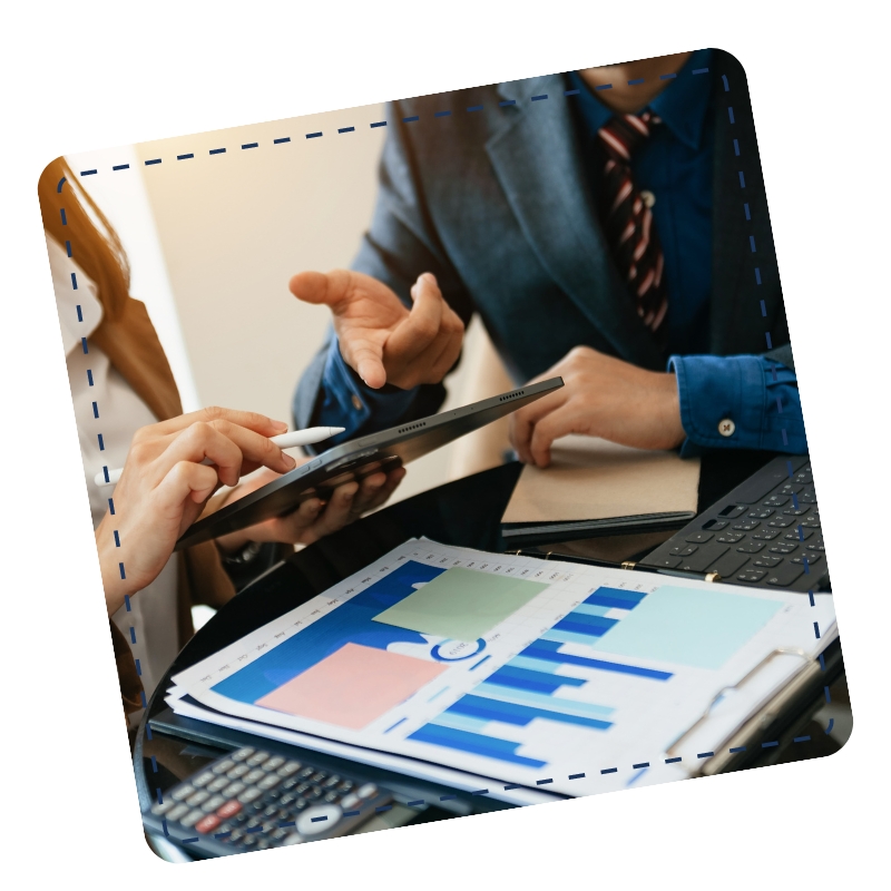 A man and woman, a BAS Agent consultant in Greenwood and a client, reviewing information on a tablet computer while sitting at a table.