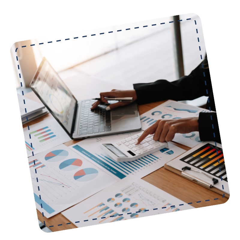 A bookkeeper in Doubleview working at a desk with a calculator and laptop.