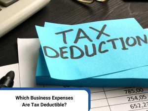 Tax deductions for small business concept with sticky note reading 'Tax Deduction' on desk with financial documents.